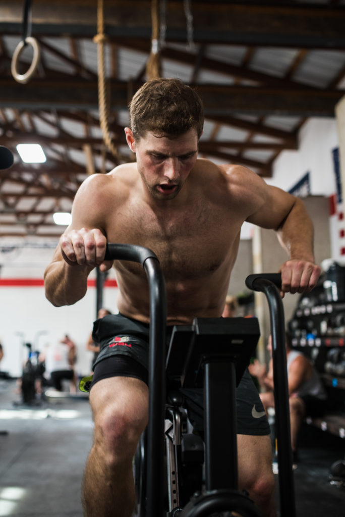 Man peddling on Rogue Bike at CrossFit SISU Excelsior