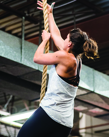 woman climbing rope at CrossFit SISU Plymouth, MN